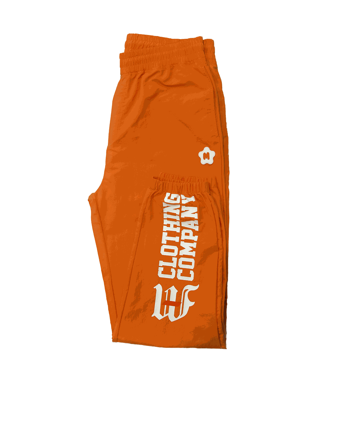 Orange nylon pants with multi-graphic prints, elastic waistband, and Miami Clothing Co. logo.